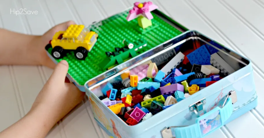 A lunch box filled with Legos to keep kids entertained on long trips