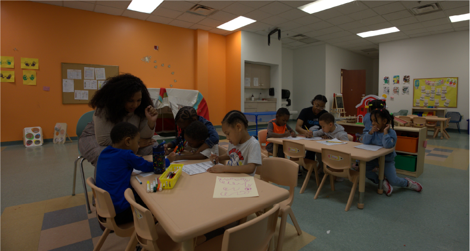 Teachers sitting with kids and teaching